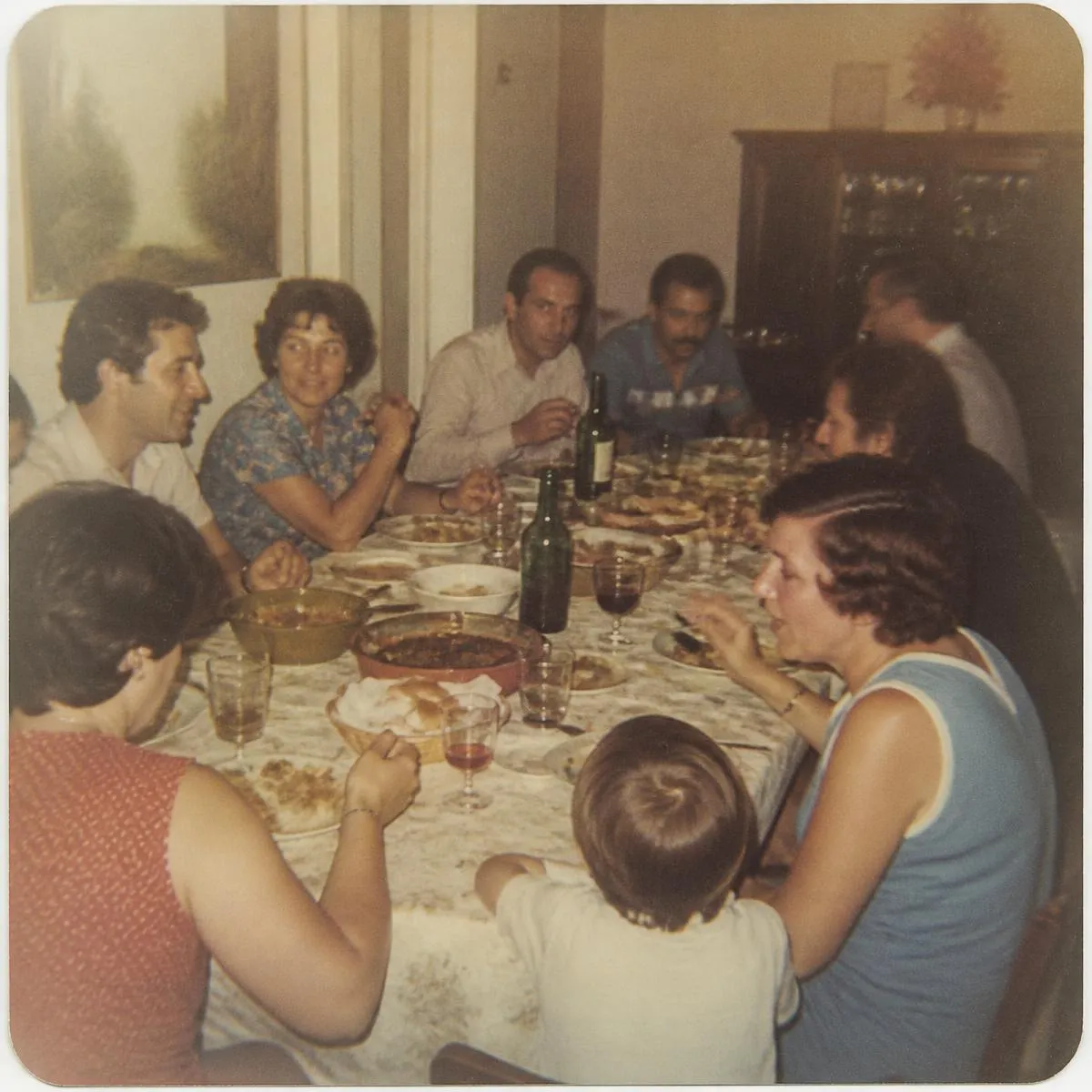 A faded family snapshot of a crowded dinner table
